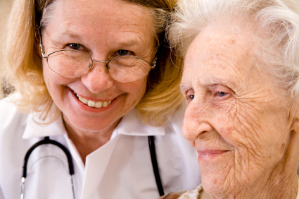 Up close picture of a nurse and patient both smiling.